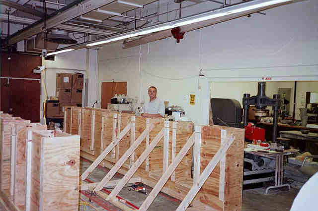 The formwork shows wooden boards attatched to wooden poles.
